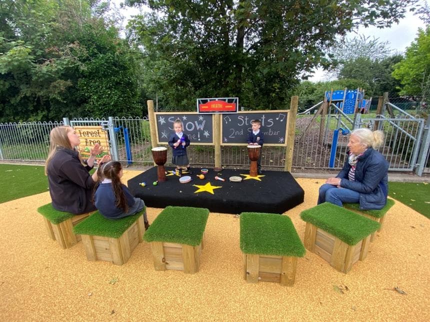 children sitting on movable seating in their playground