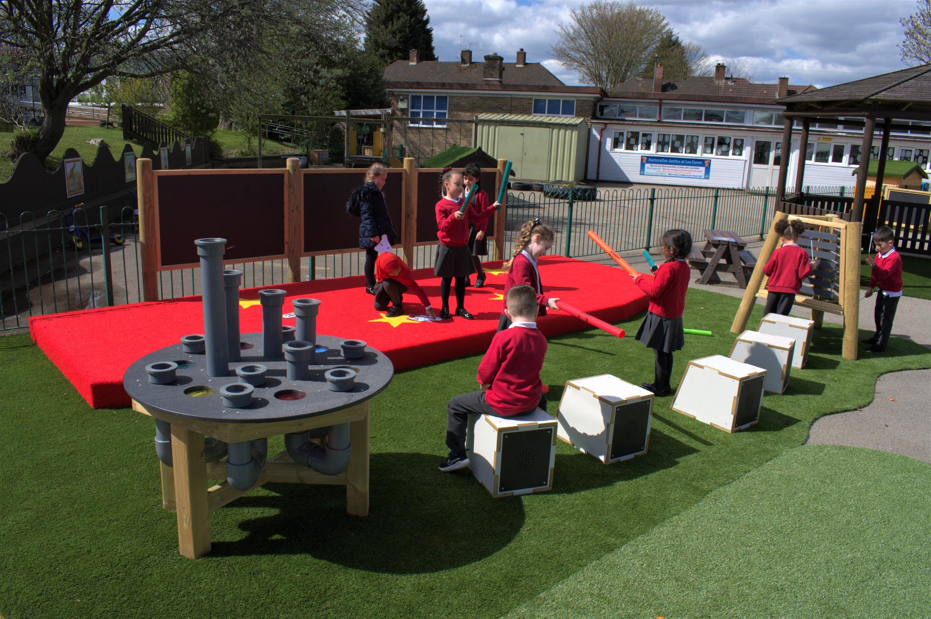 A class of children performing on their musical play area