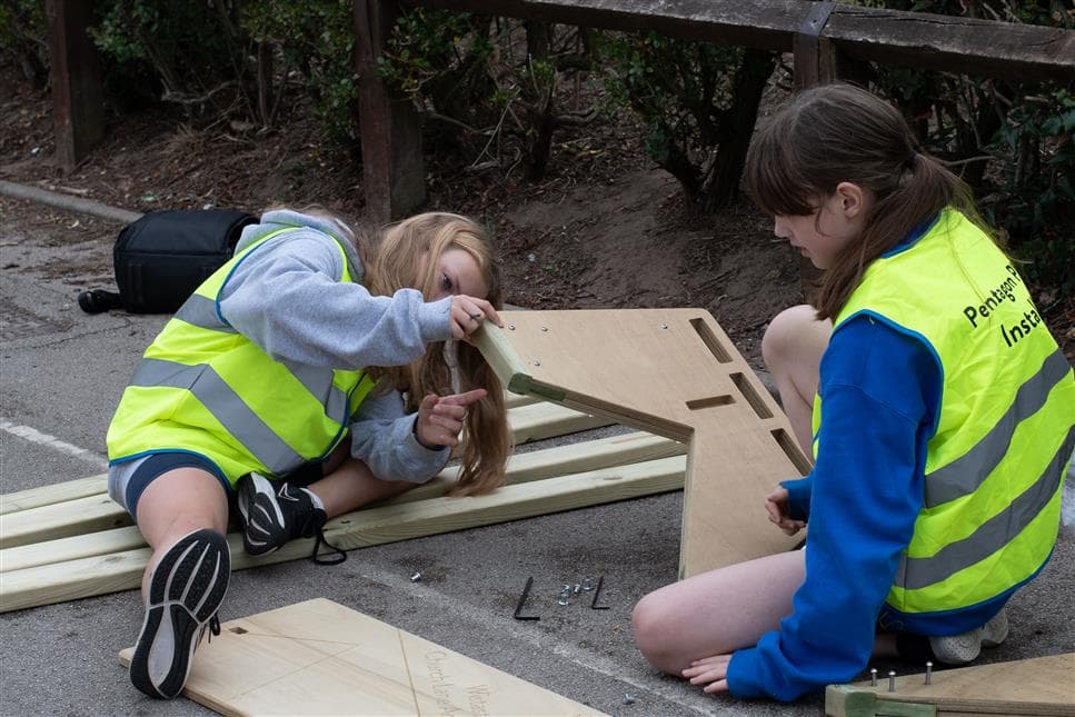 two years six girls constructing their leavers bench