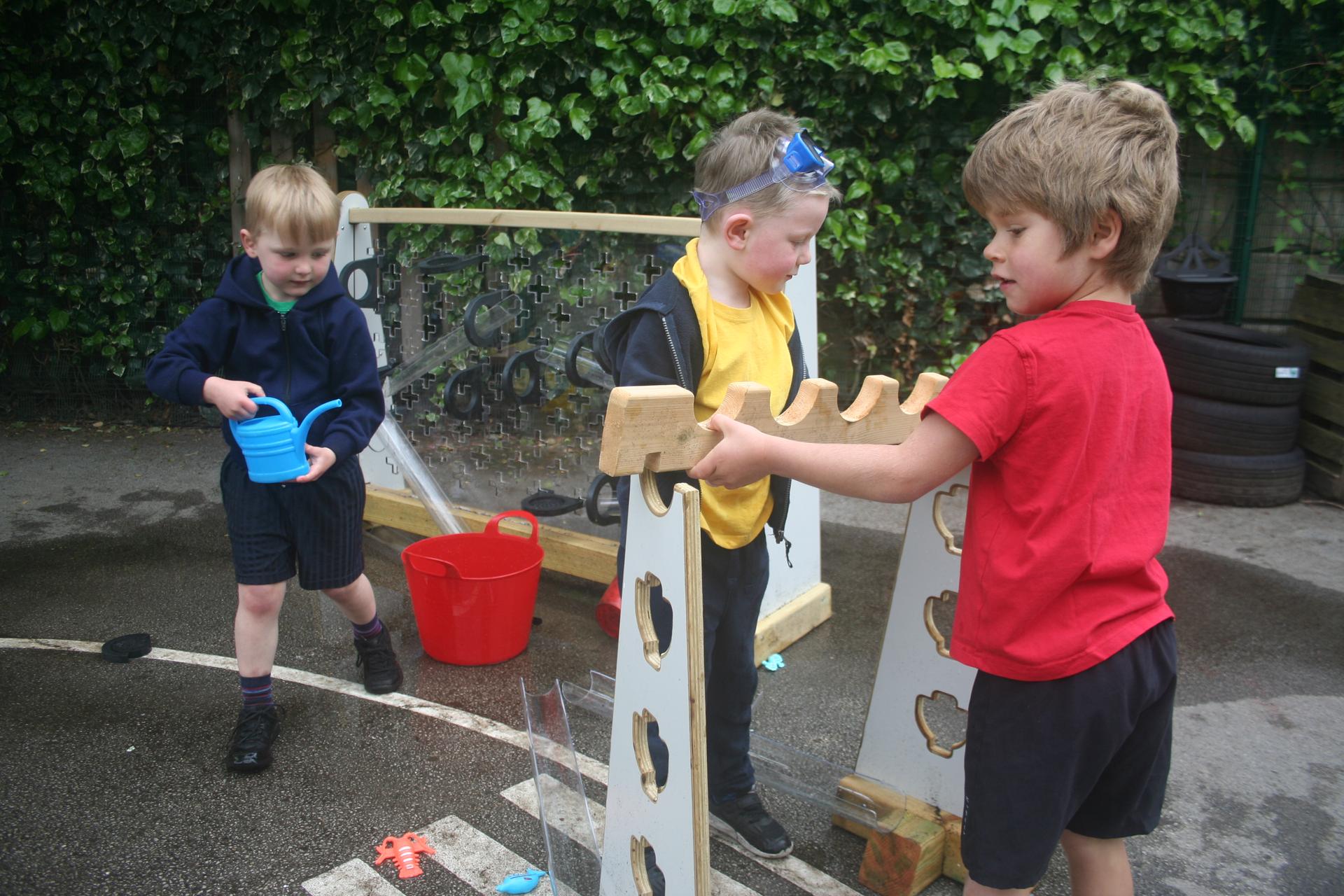 Children working together to connect together the Water Channel Stands 