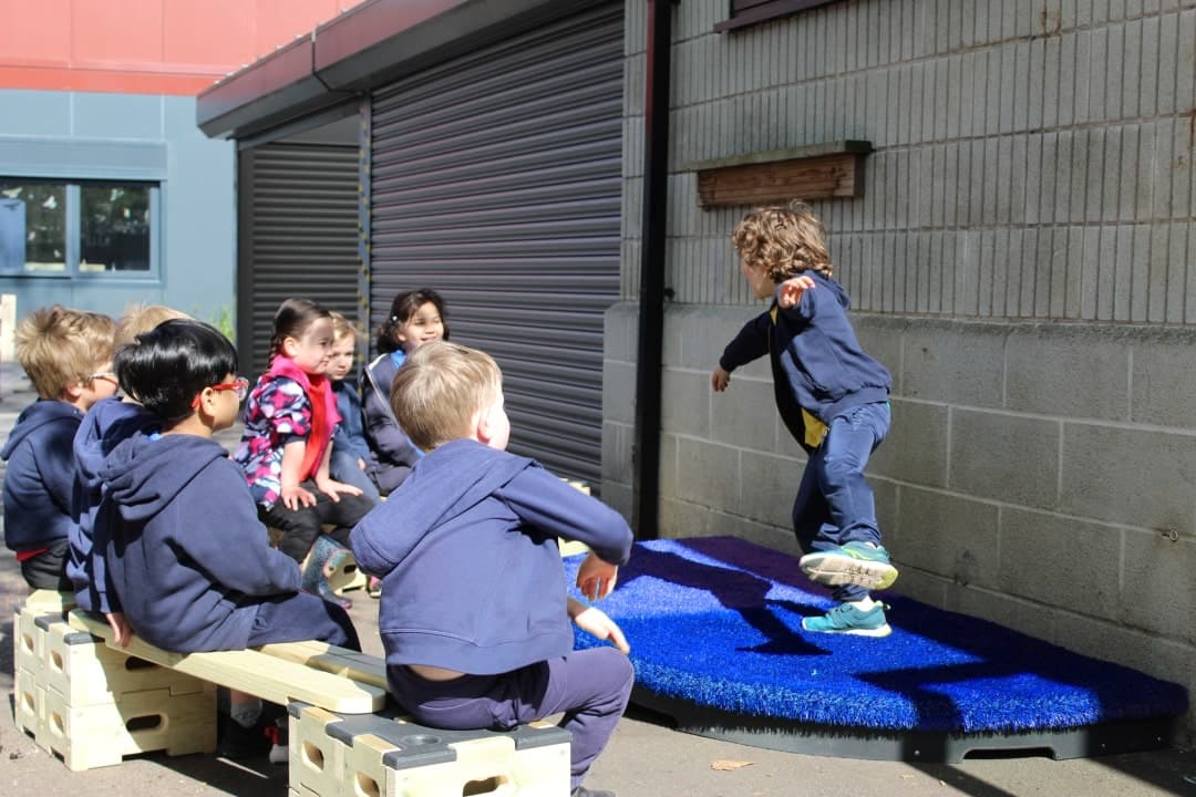 Children enjoy performing on the blue performance stage
