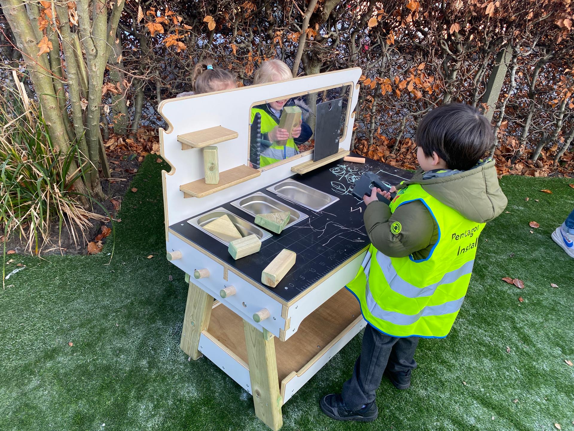 A young boy using the construction table in his school