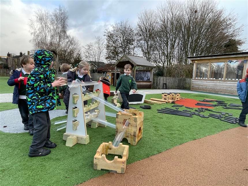 Children using the Loose Parts Play Package in their playground at school
