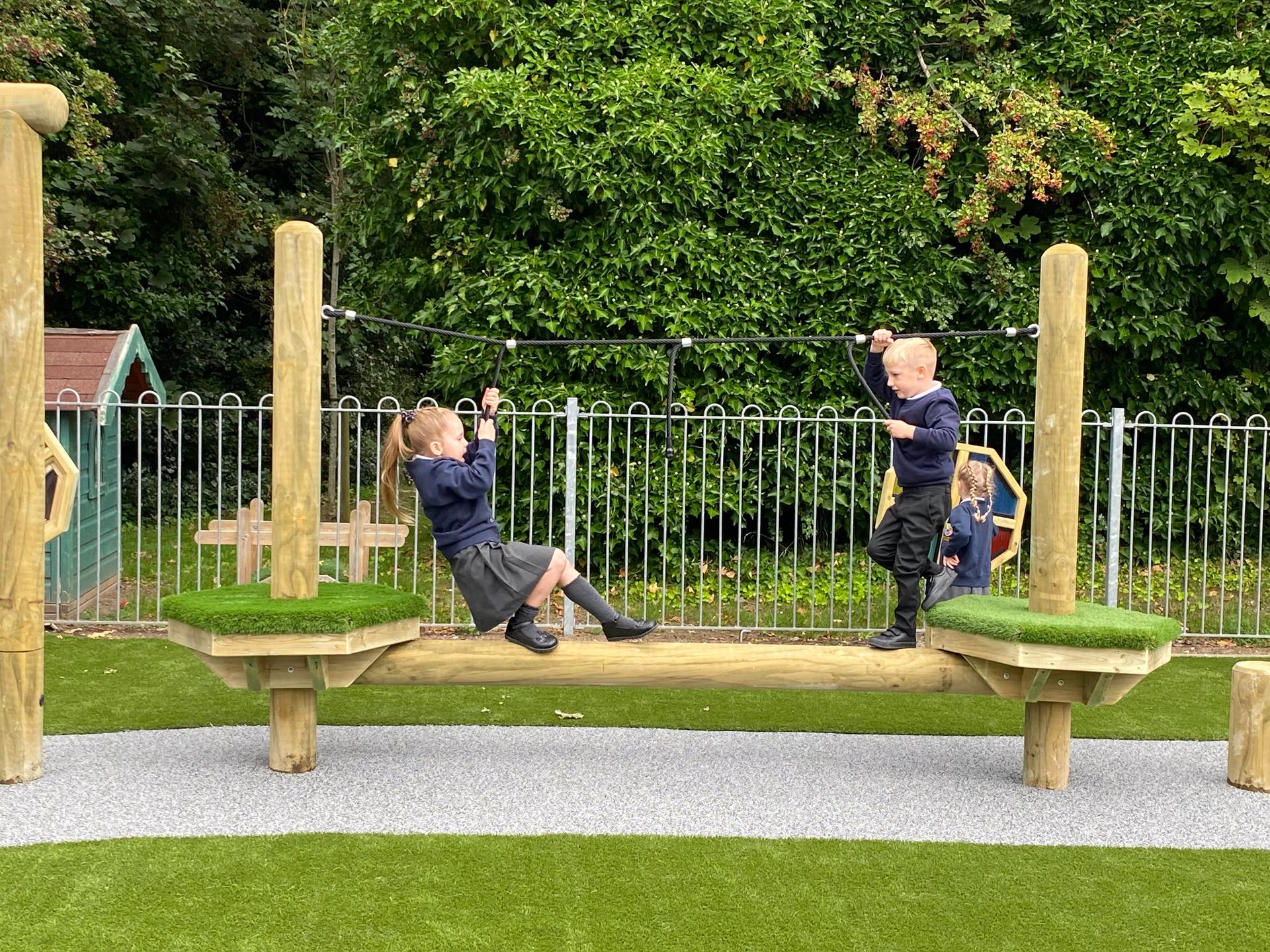 2 children playing on the platform of their forest trim trail