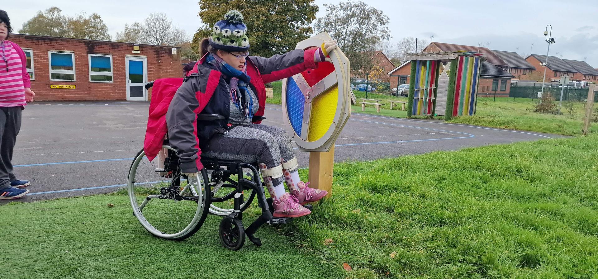 Girl in wheelchair spinning our sensory wheel