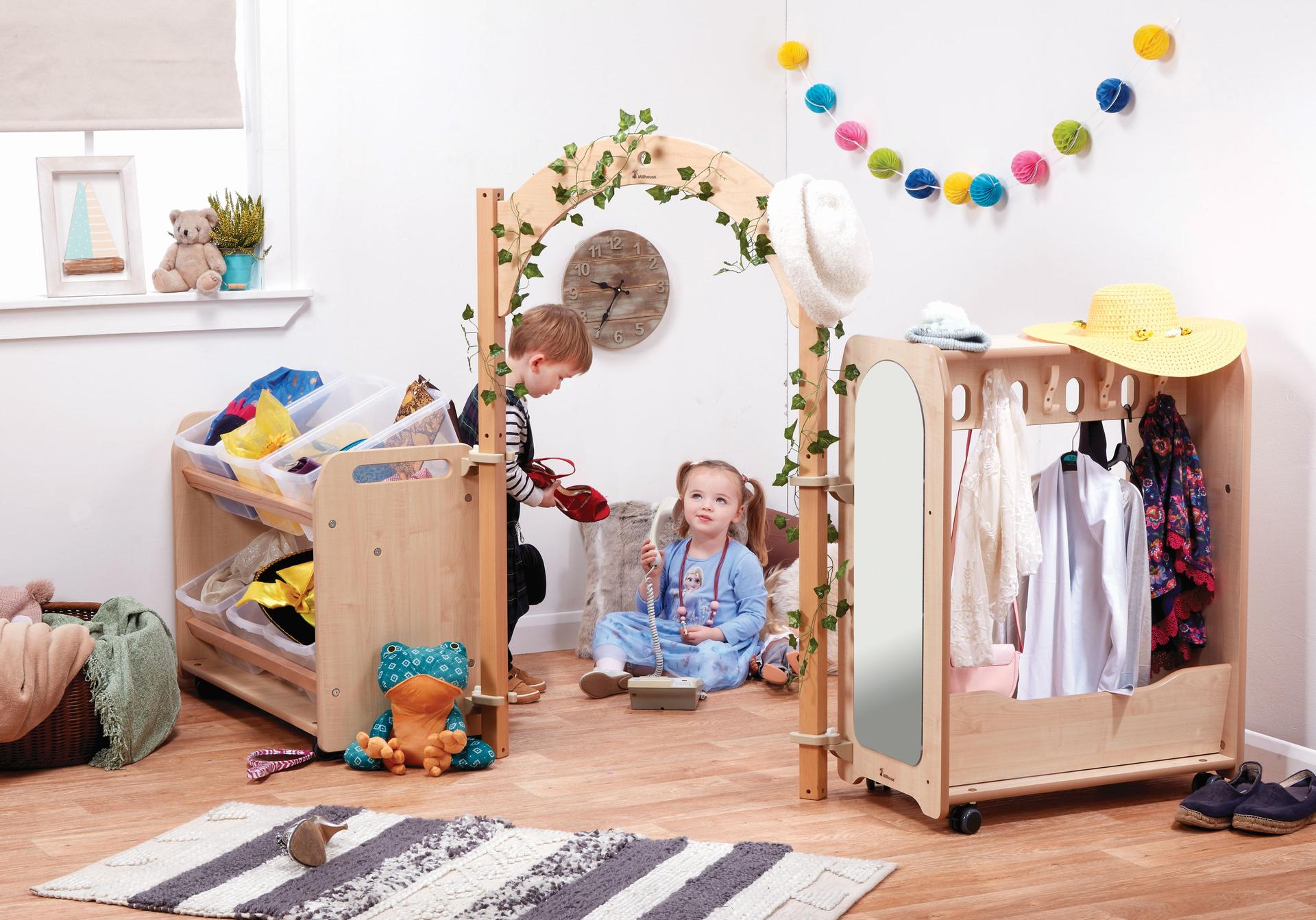 Two Toddlers are playing dress up in the Mini Toddler Dressing-Up Zone with Baskets.   