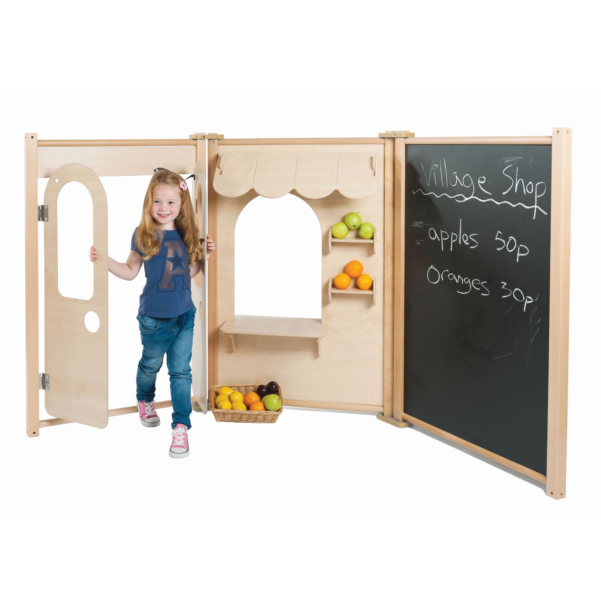 A young girl is playing with the Maple Panel Shop Set, she is pretending to sell apples and oranges.
