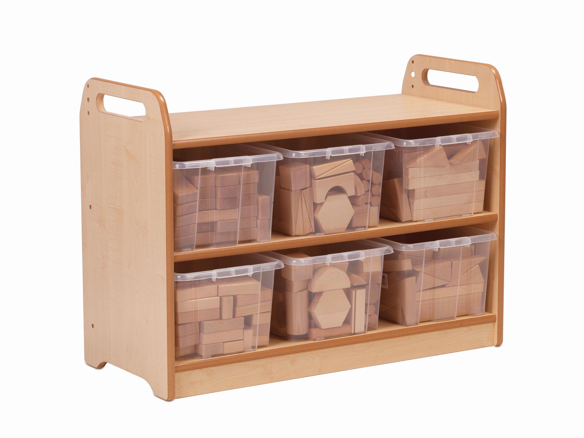 A wooden storge unit and bench with six clear tubs underneath filled with classroom building blocks.