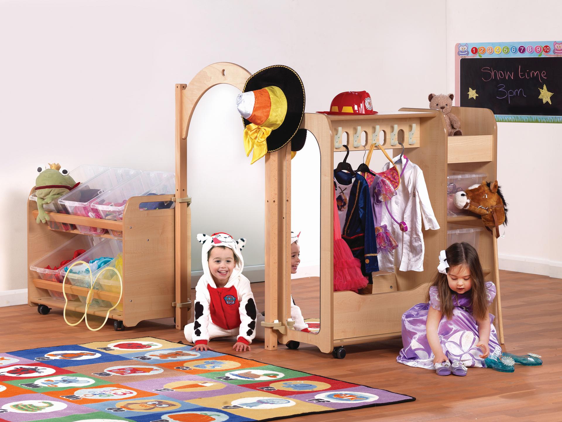 Two Pre-school aged children are playing dress up in the Mini Preschool Dressing-Up Zone.