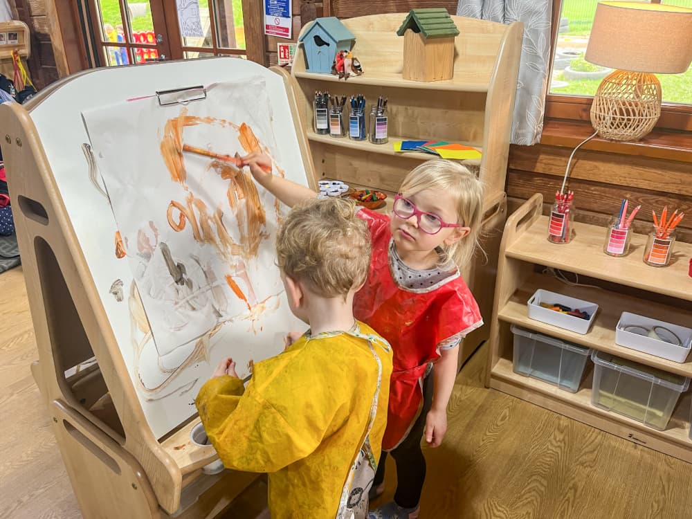 Children drawing on Millhouse Art Easel
