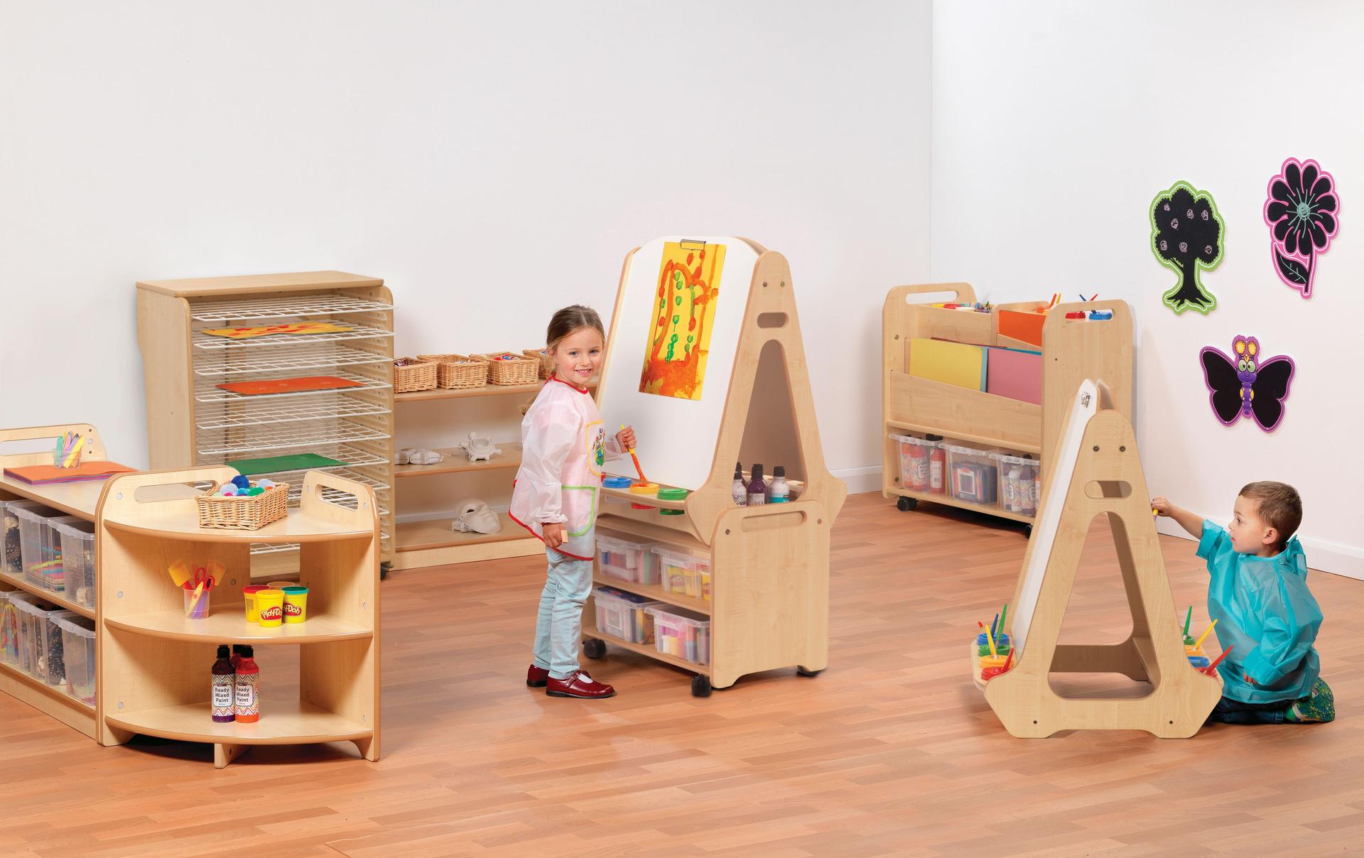 Two young children are painting on two easels withing the Creativity Zone with Clear Tubs.
