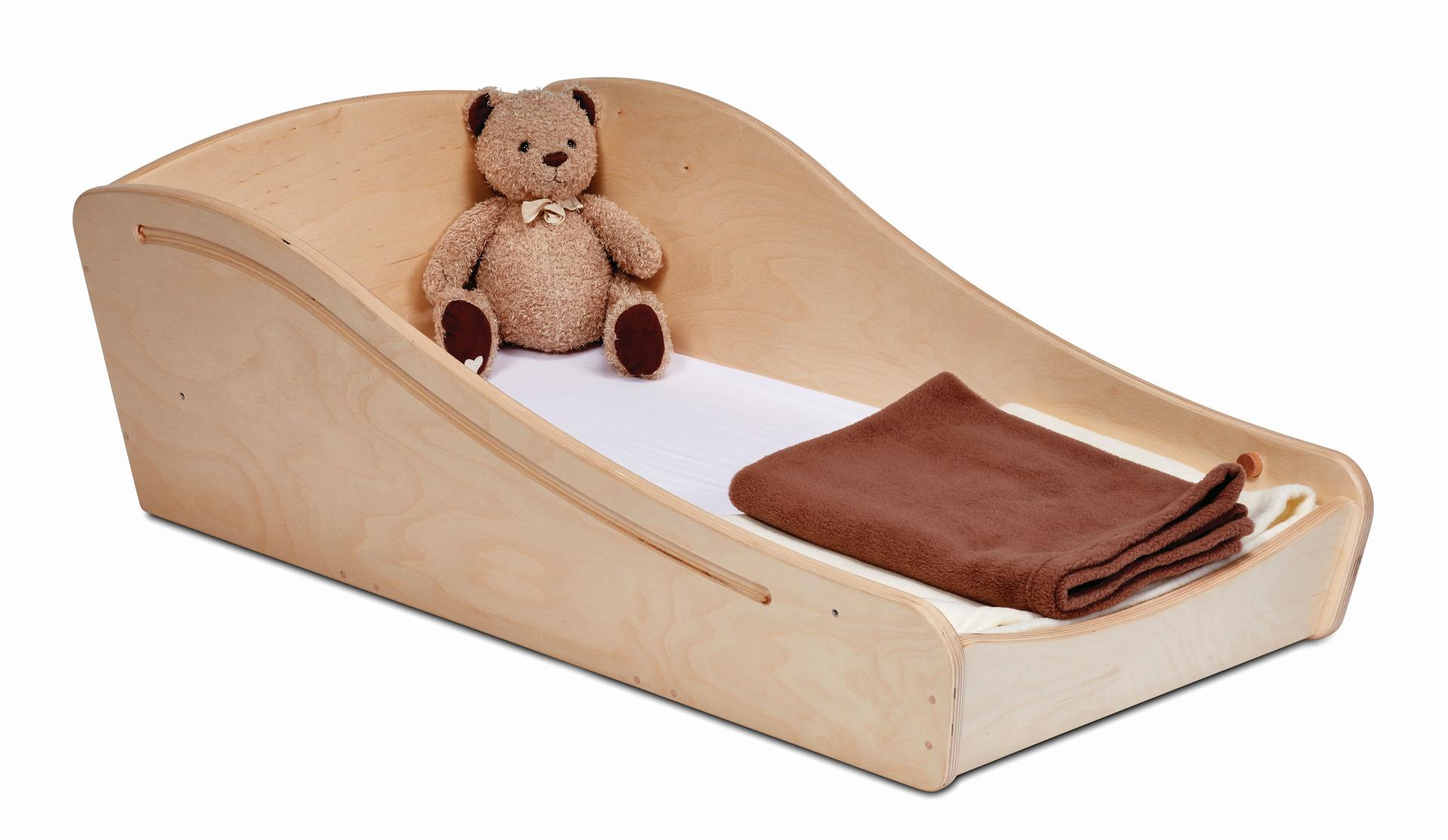 An empty wooden sleeping pod for babies and toddlers with a brown blanket and teddy.