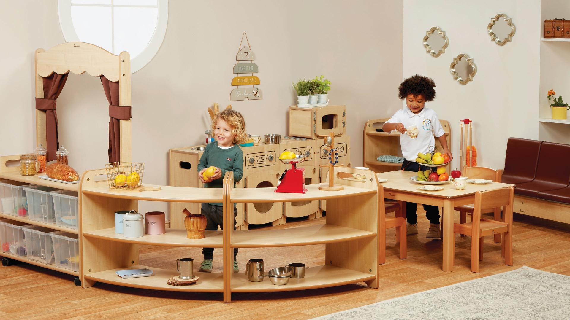 Two young boys play in Home Zone With Clear Tubs and Taupe Curtains, in a classroom.