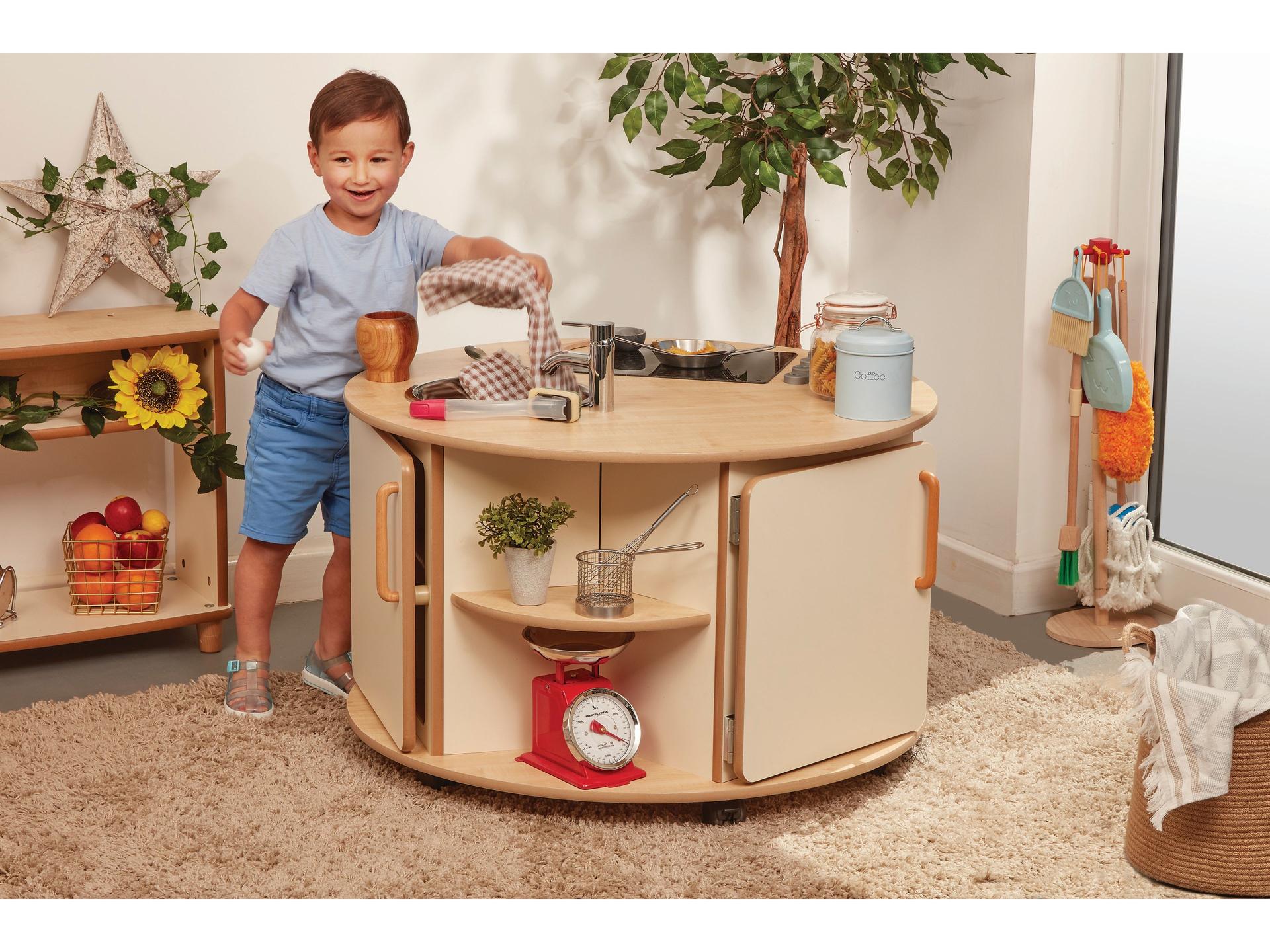 millhouse round role play kitchen unit with storage cupboards and child playing