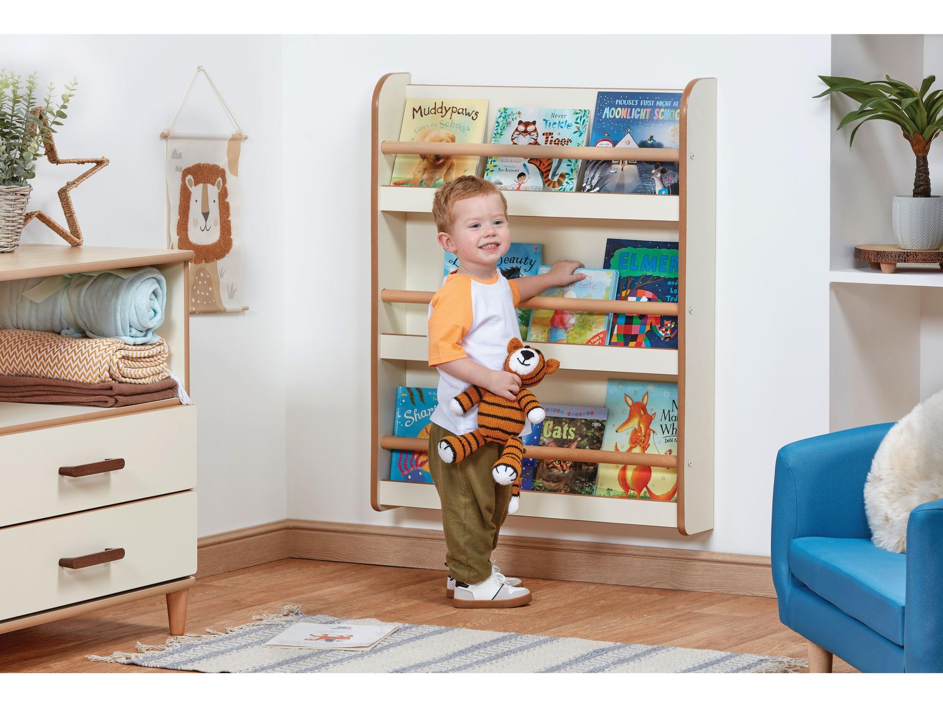 millhouse wall mounted book shelf unit with child reaching for one of the three self select shelves