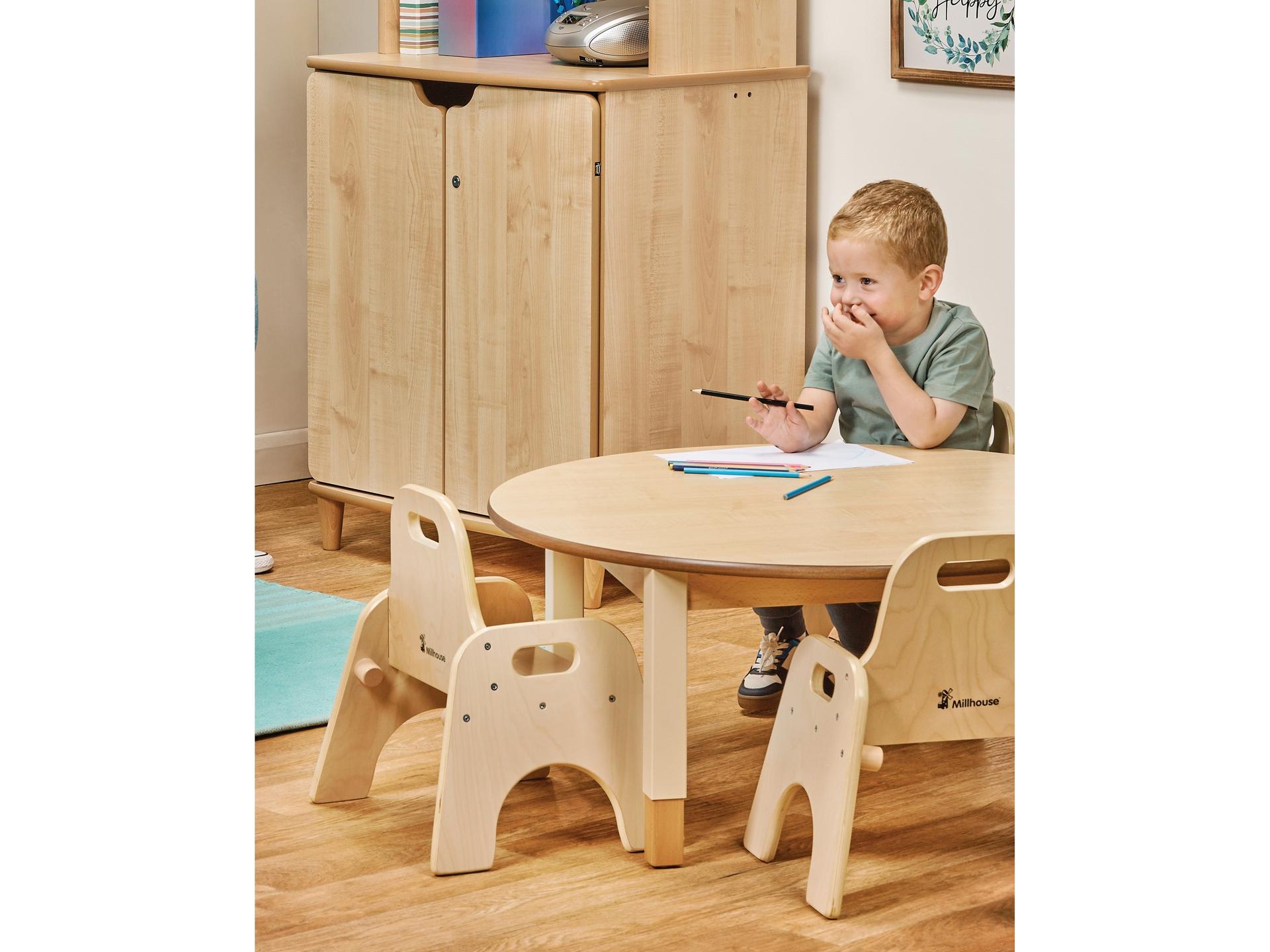 millhouse circular chair and table set with four chairs and child sat drawing