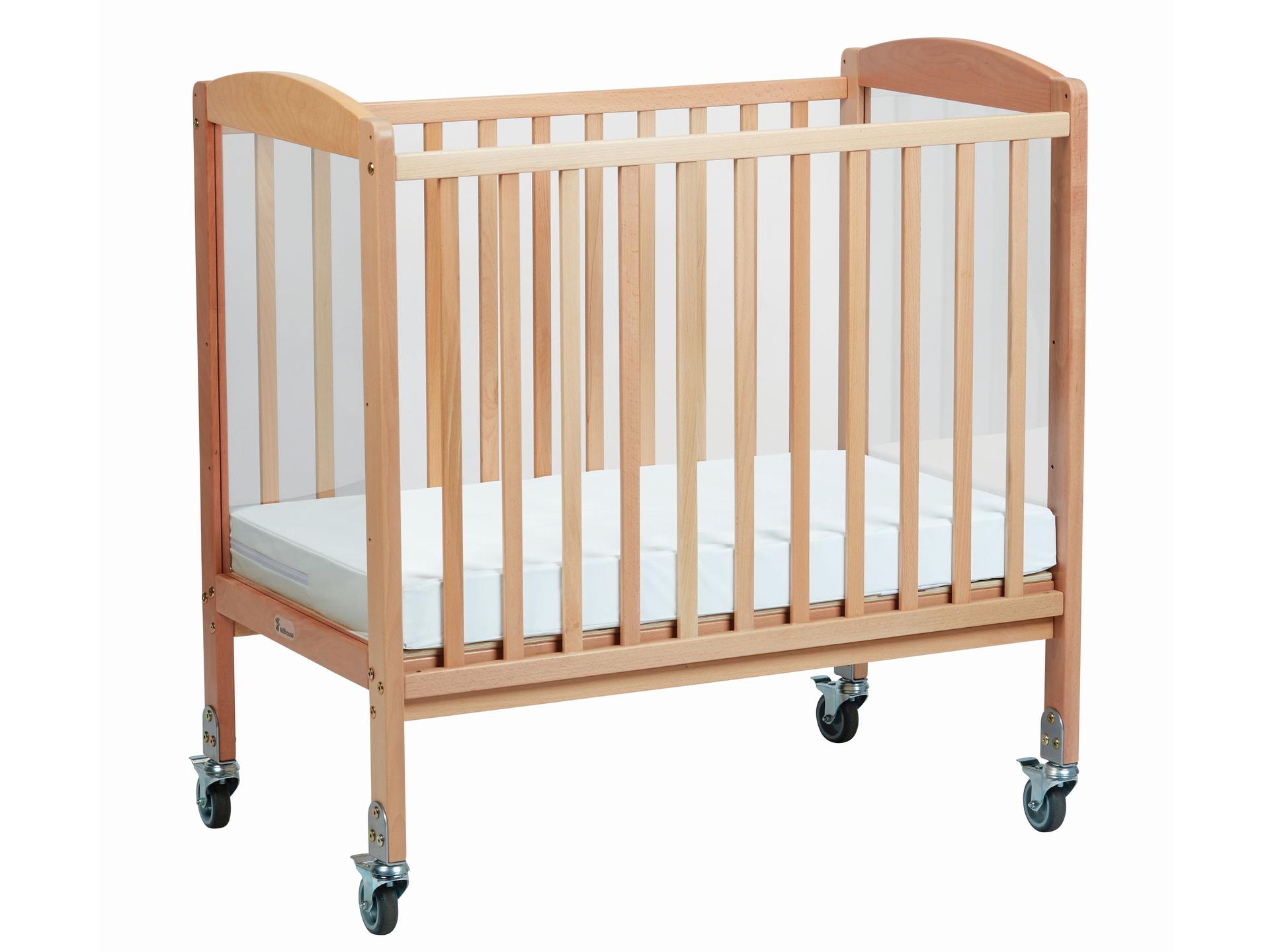 millhouse wooden cot on wheels with padded white mat inside