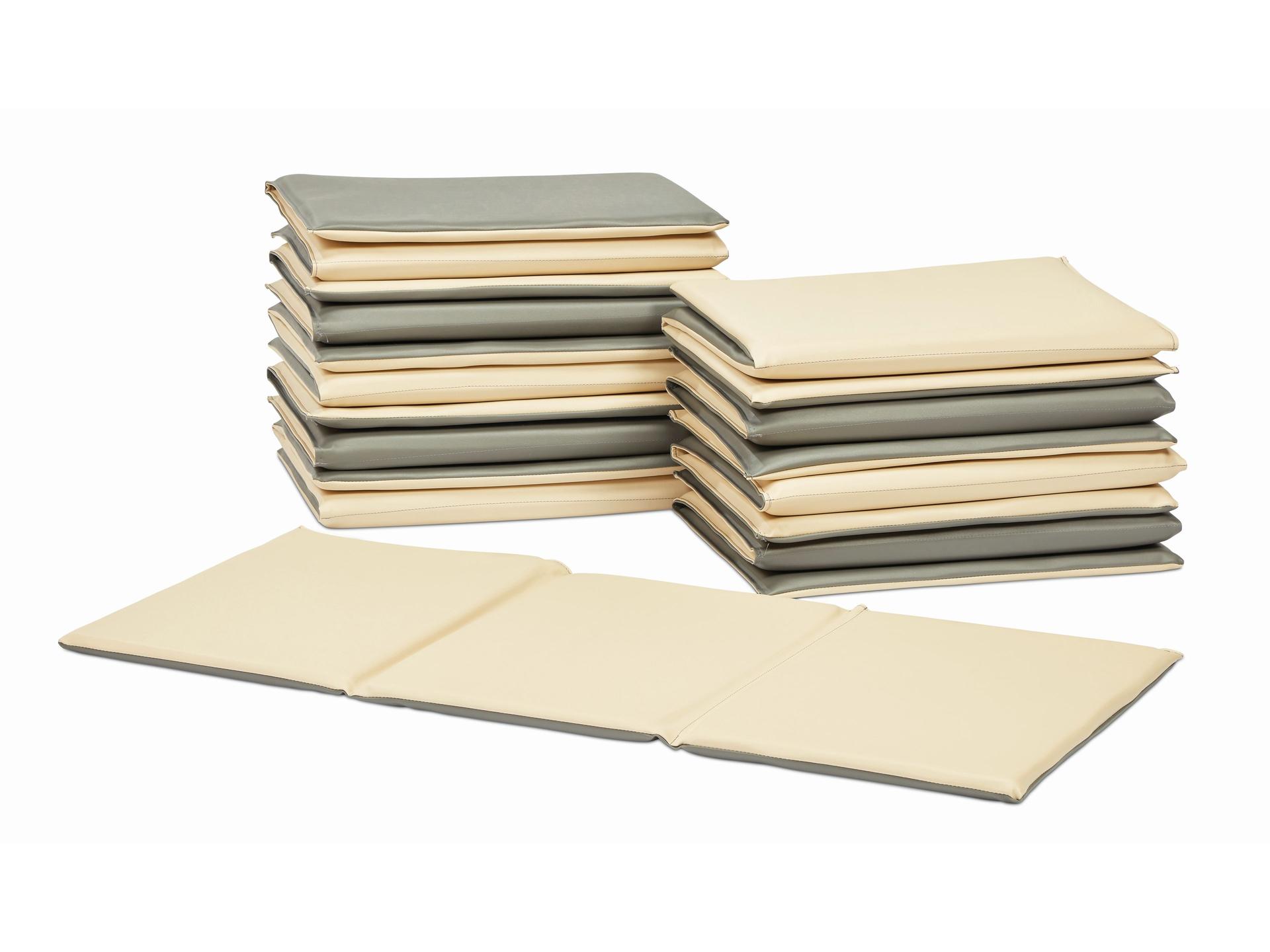 millhouse baby mats stacked and one unfolded to show the length, colours are cream on one side and grey on the other