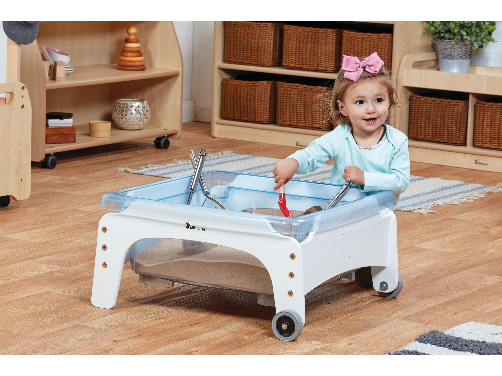 millhouse white sand and water box with toddler playing in an eyfs setting