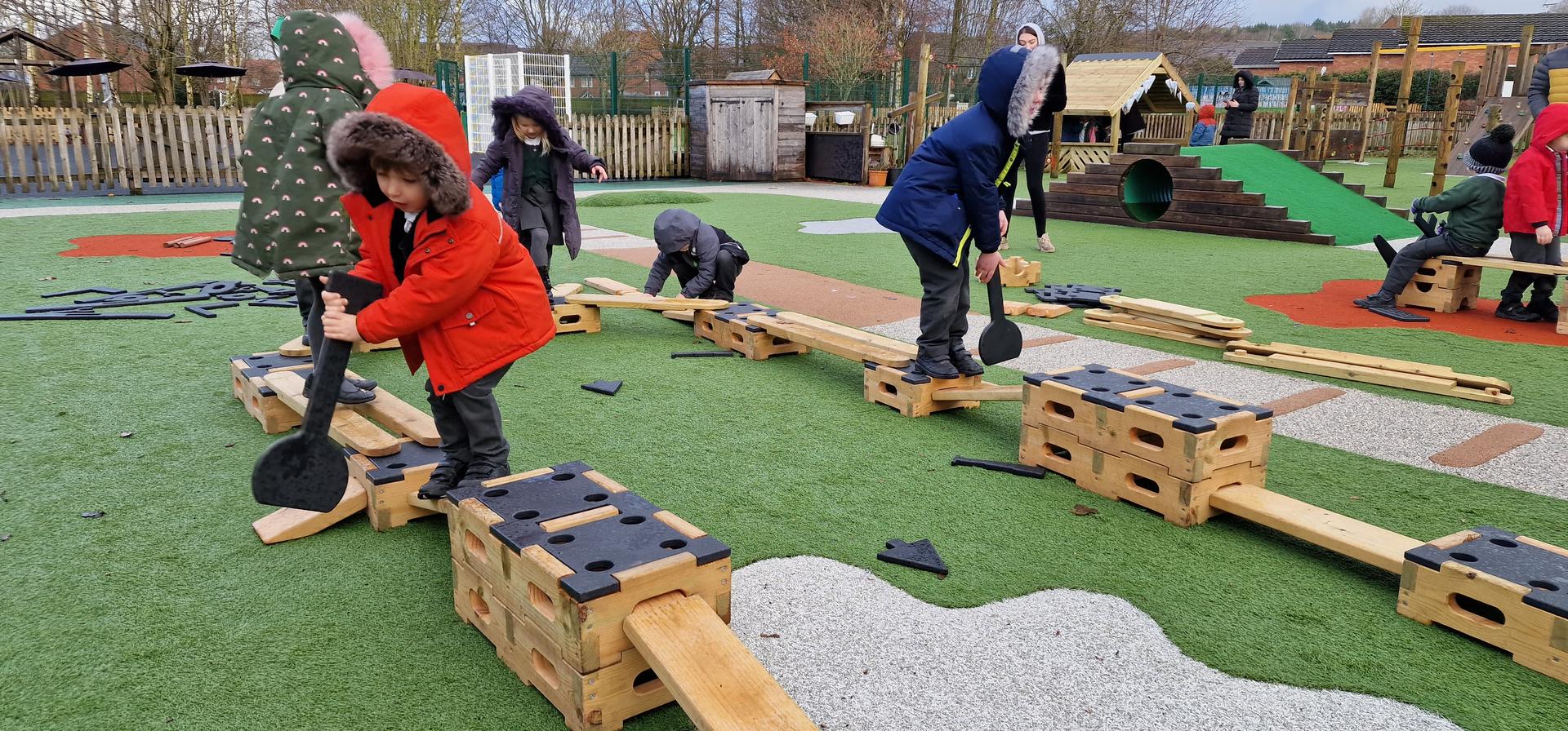 children creating a trail with planks and blocks