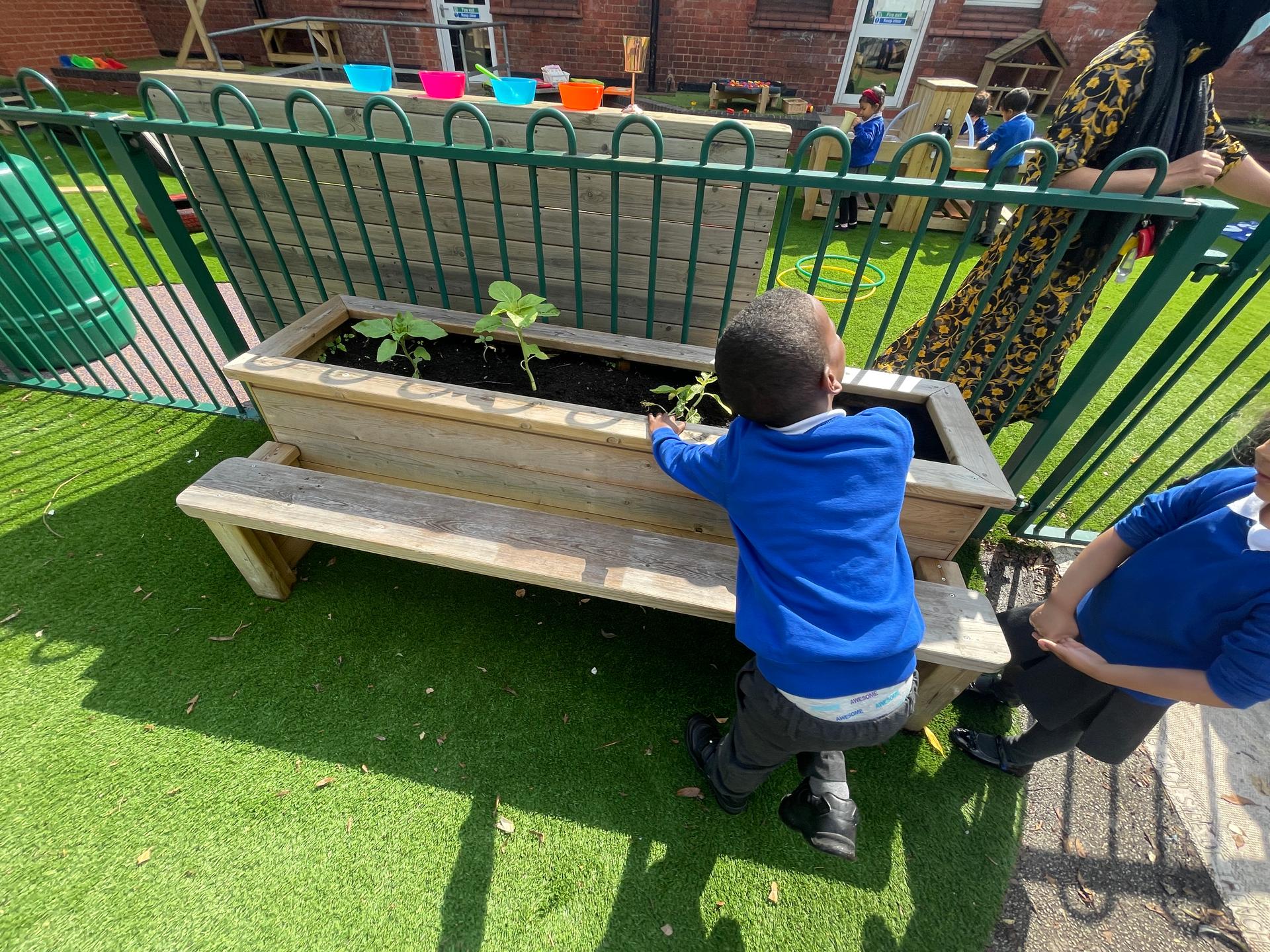 One child sat down planting flowers