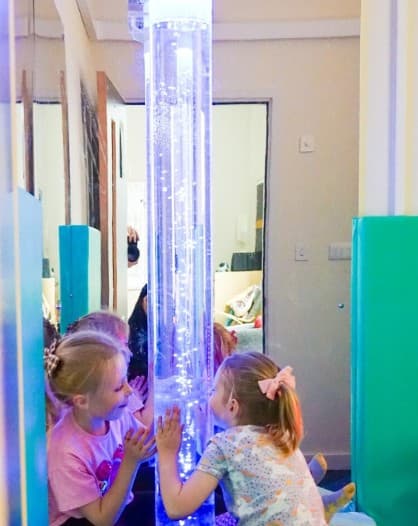 children looking into bubble tube