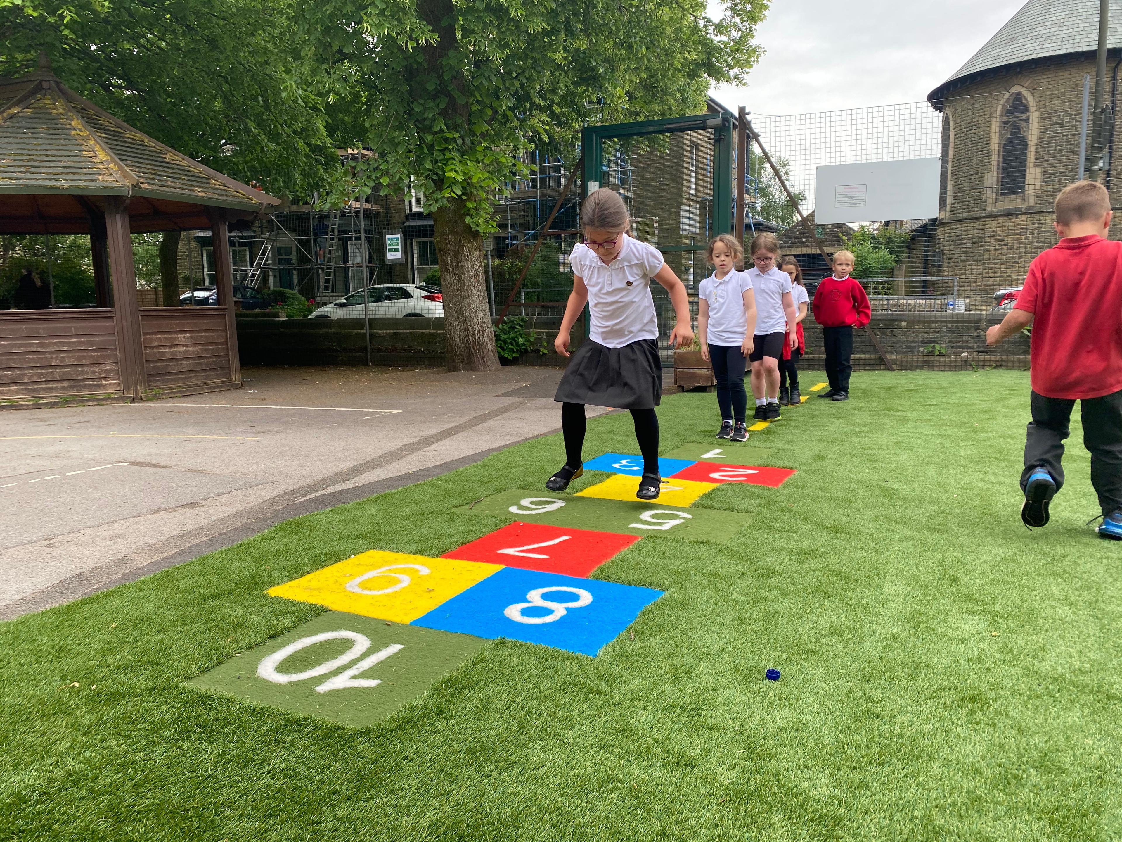 one girl playing on hopscotch