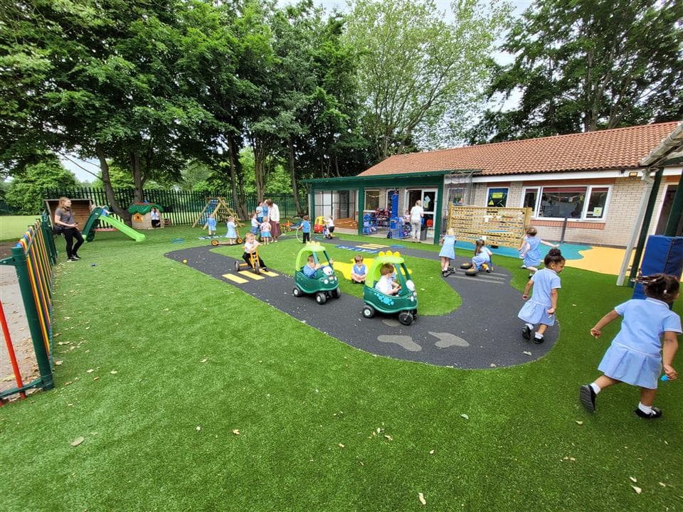 children playing on bikes on our Wetpour roadway