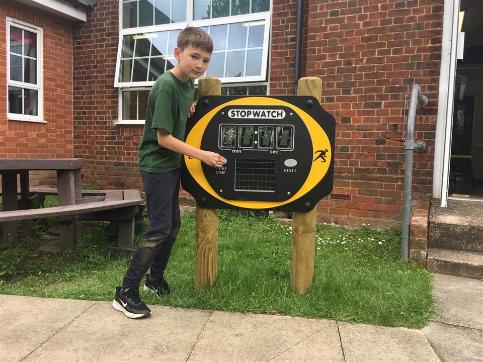 a boy standing next to our stop watch