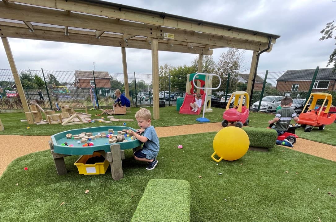 a little boy playing with our tuff spot table