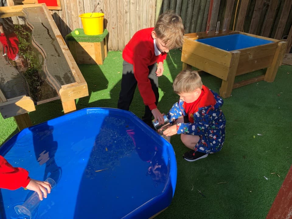 children playing with a tuff spot table