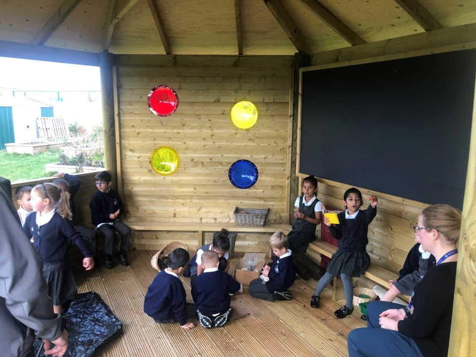 the giant chalkboard in the hexagonal gazebo being used as part of an outdoor classroom