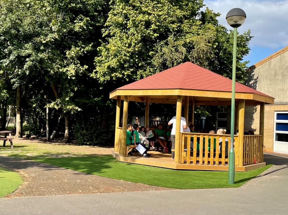 children sitting in the gazebo with the decked base