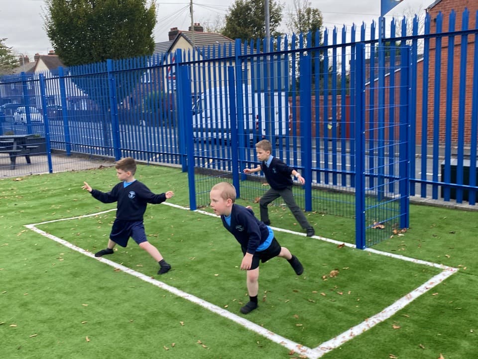 the goal end of a MUGA pitch being used in a football game