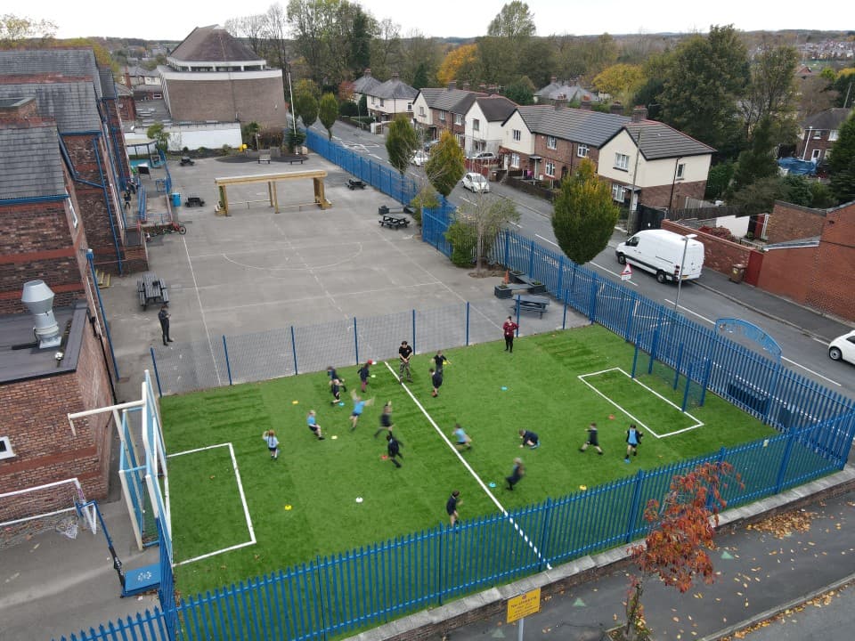 a birdseye view of a primary school MUGA being used for sports