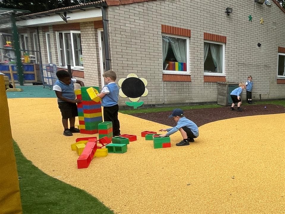 two children playing on our wetpour