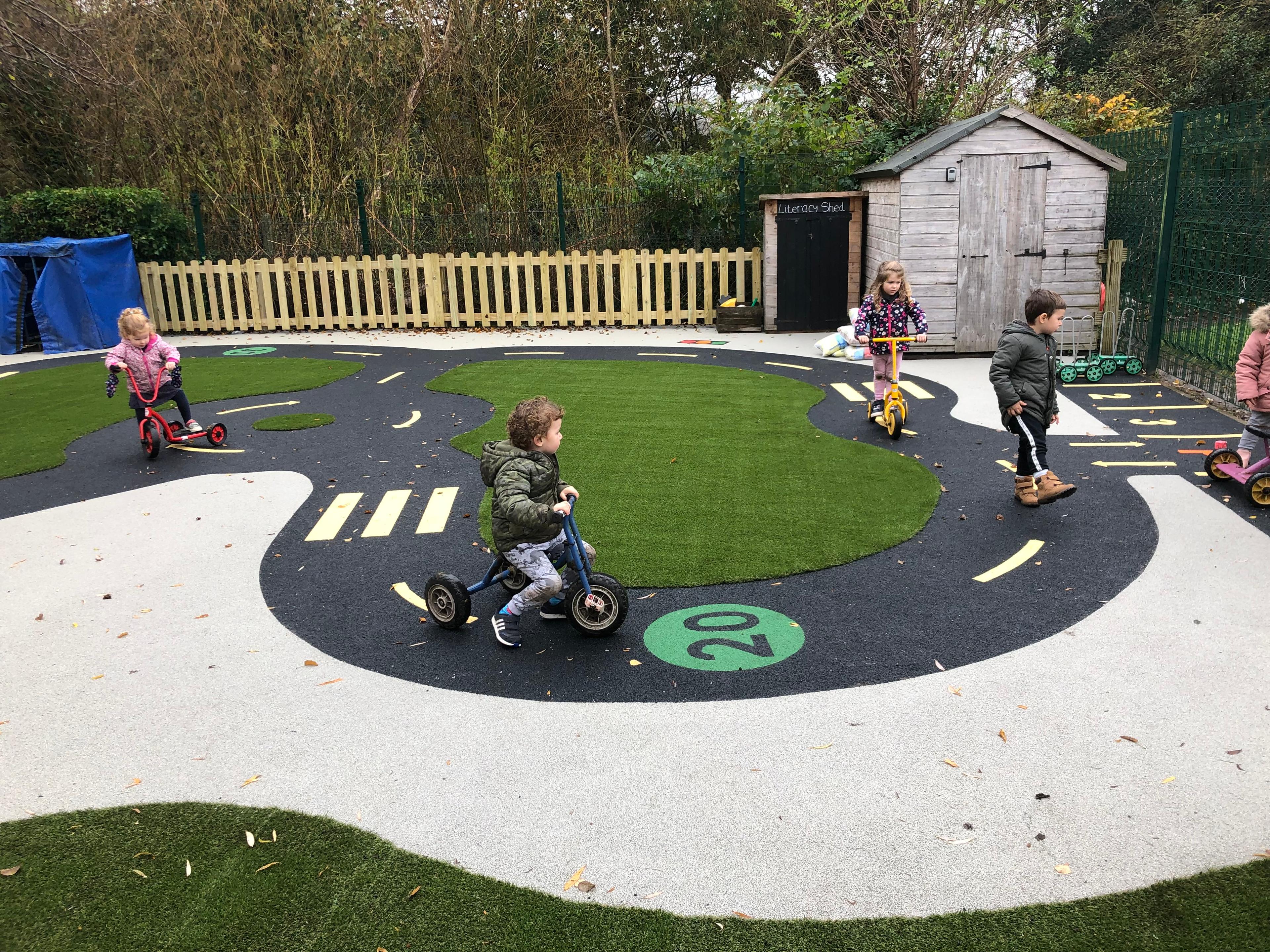 A birds eye view of children playing on the Wetpour roadway.