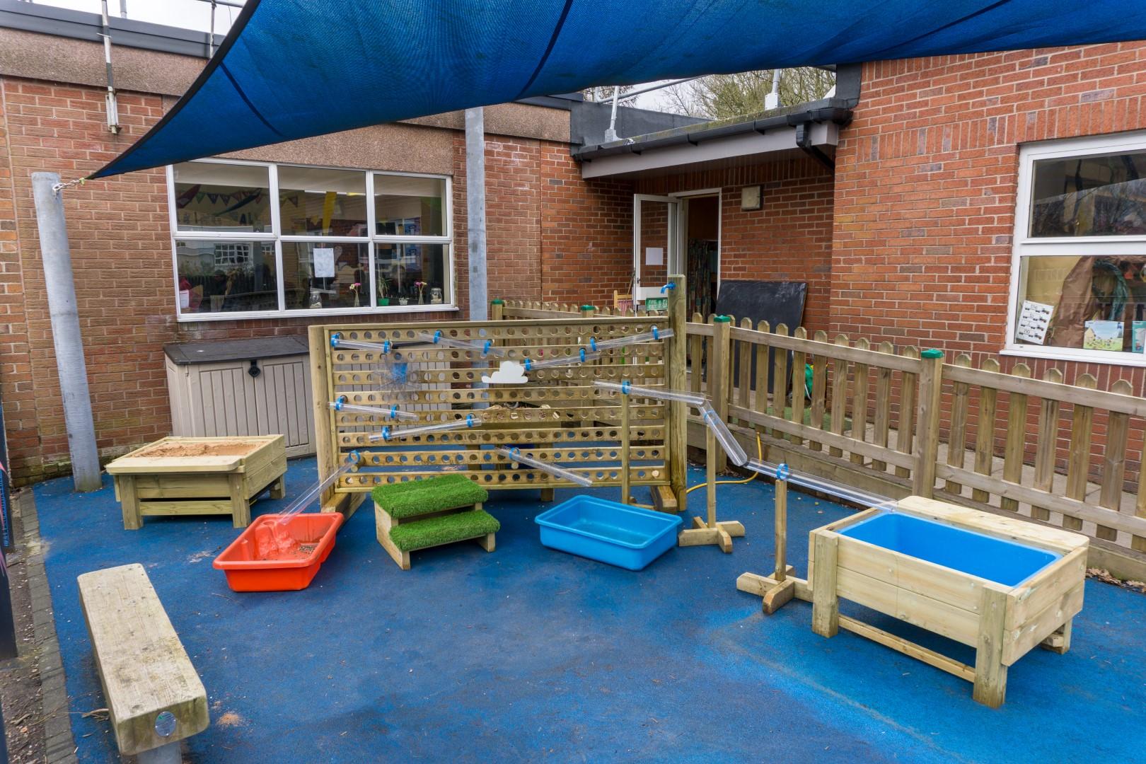 An image of the Water Wall with Water Play Package in an early years playground