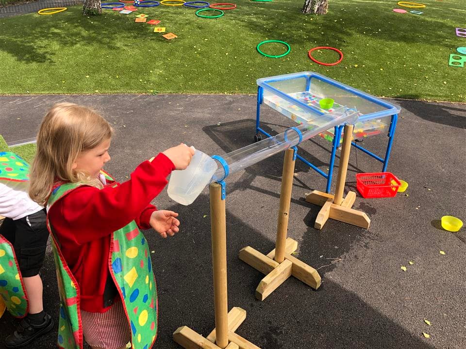 a girl playing with the waterwall