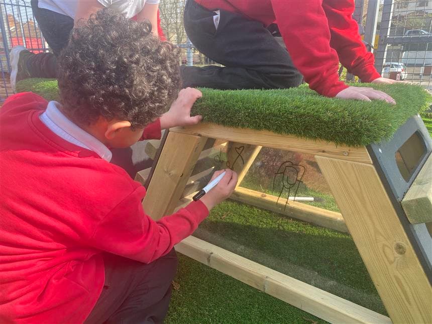 A young boy using the mark making panel on the get set go blocks
