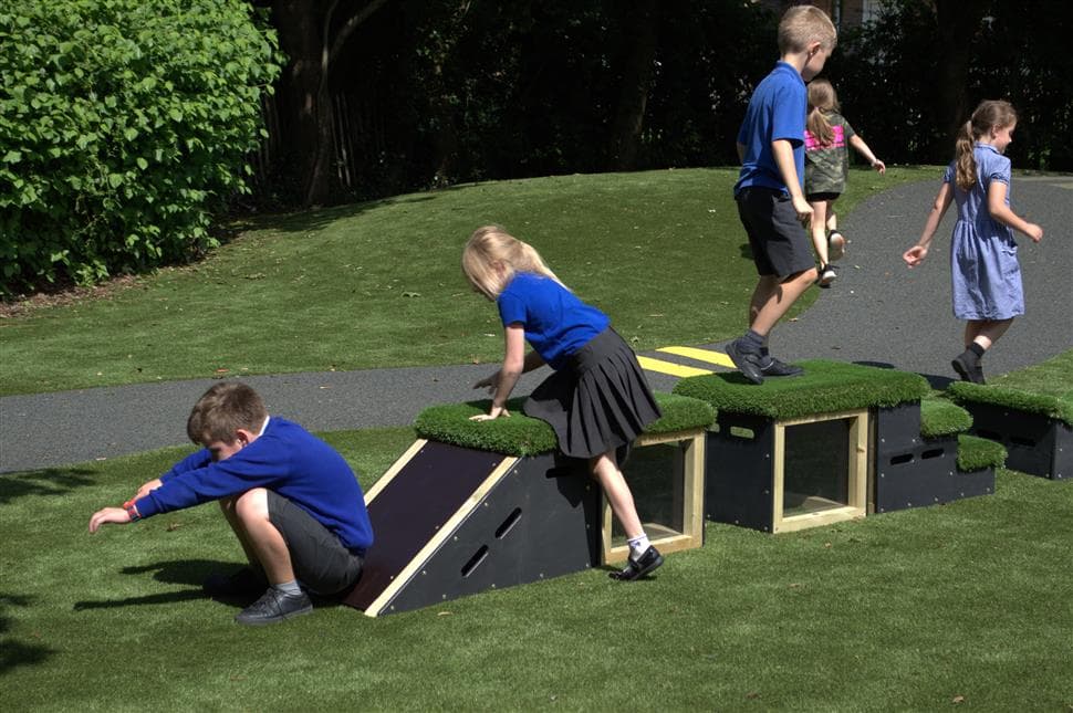 A class of children playing on the get set go blocks