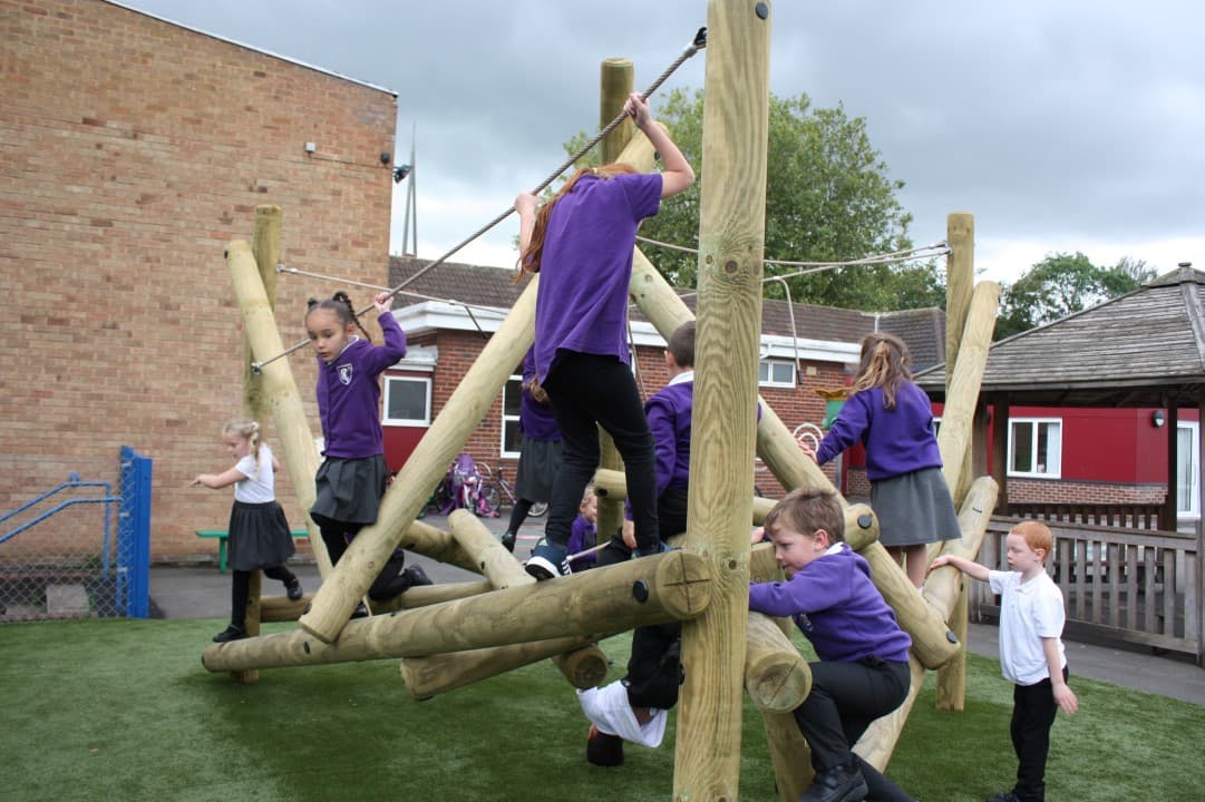 children in purple school uniform play on the harter fell