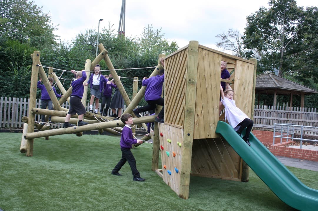 children slide down the slide and climb the climbing wall as they clamber along the harter fell climber