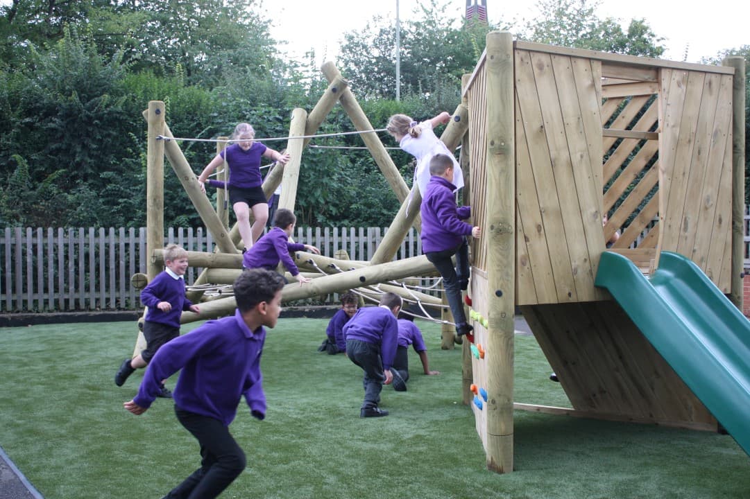 children in purple uniform swinging on the harter fell climber