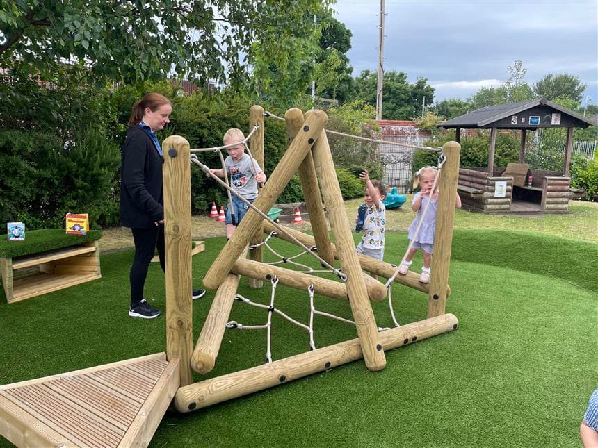Children swinging and climbing on the climbing frame in their playground