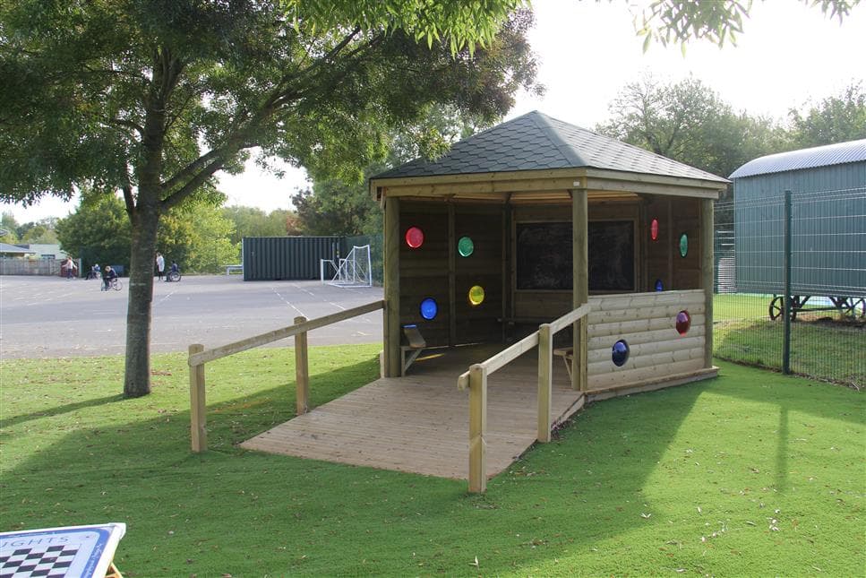 A side view of the sensory gazebo in a playground, there are no children inside