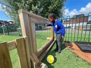 A young boy drawing on the interactive paint panel
