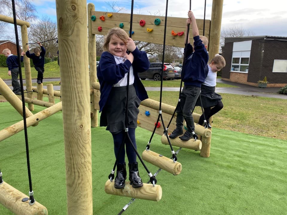 children cross the swinging log crossing