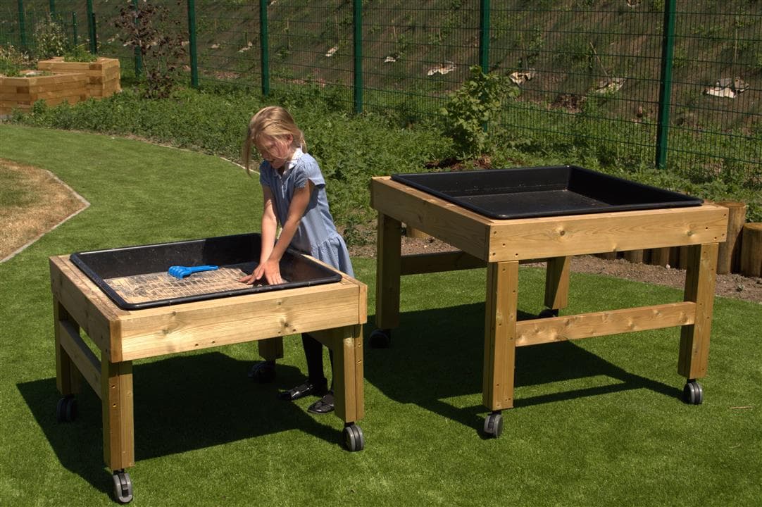 one girl playing on the nesting tables