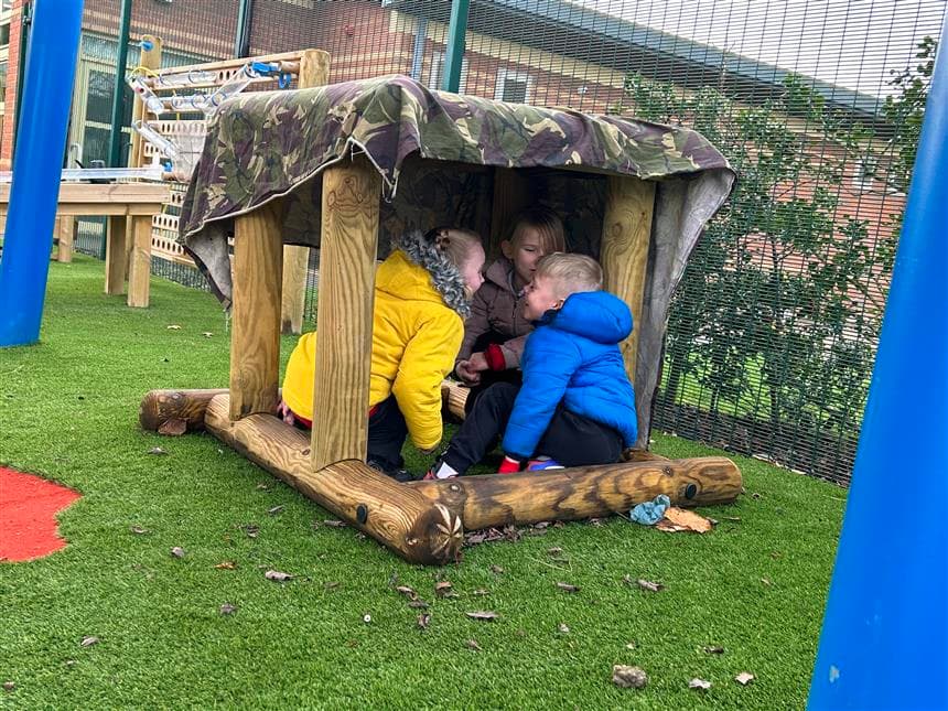 3 children playing in the sen play product in their playground